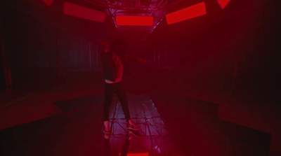 a person standing in a room with red lights