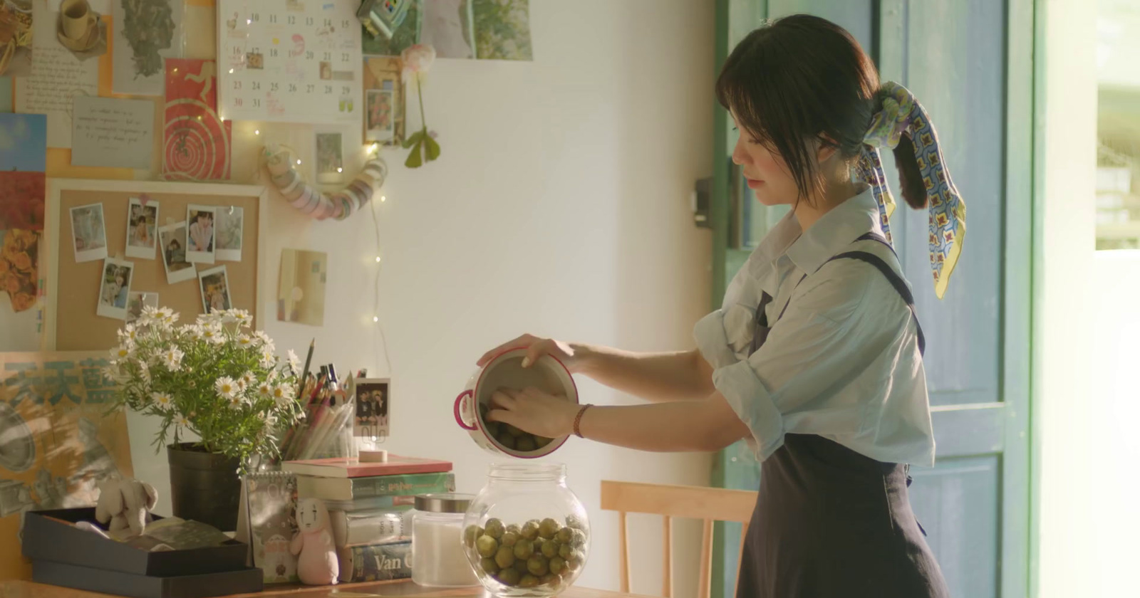 a woman is pouring something into a jar