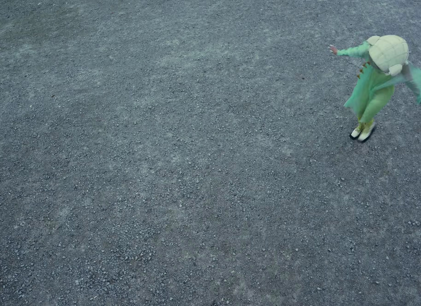 a stuffed animal is in the middle of a parking lot