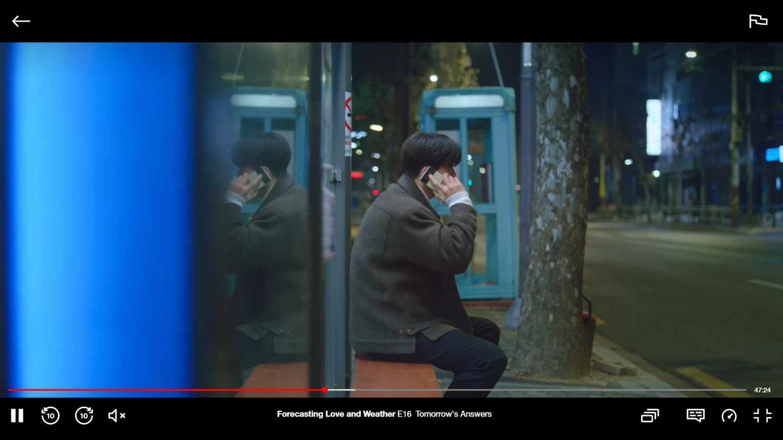 a man sitting on a bench talking on a cell phone