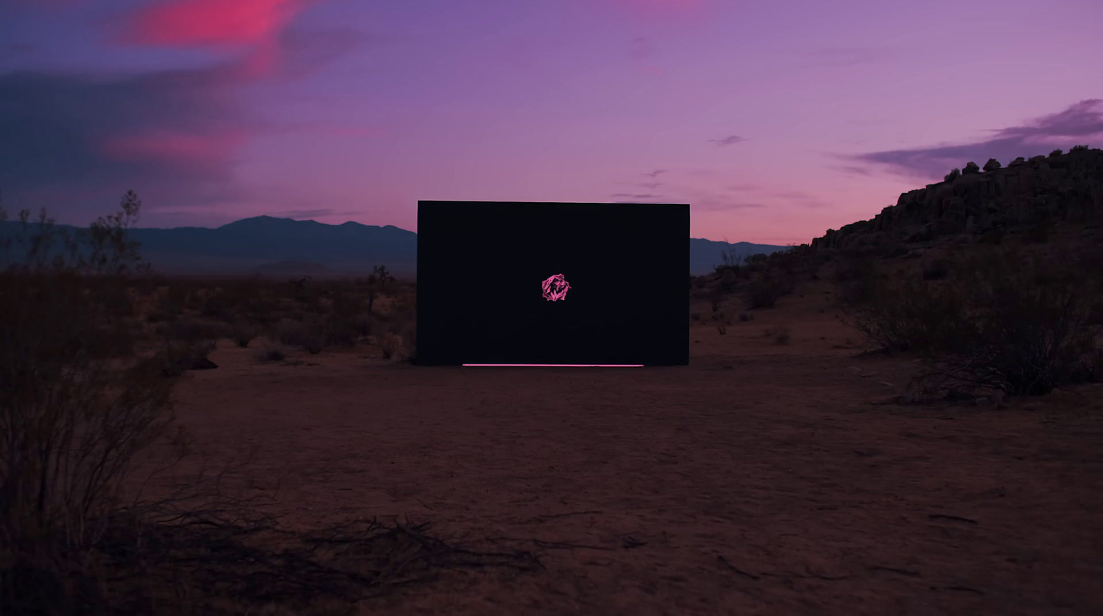 a black box sitting in the middle of a desert