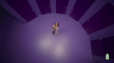 a woman standing in a room with purple walls