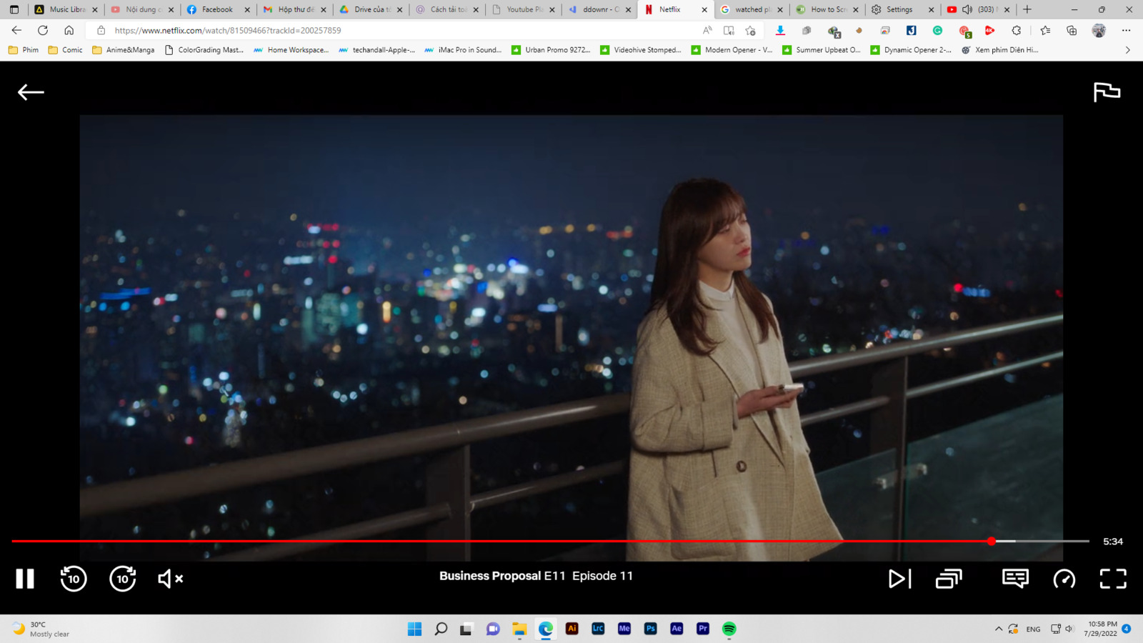 a woman standing on top of a balcony next to a city