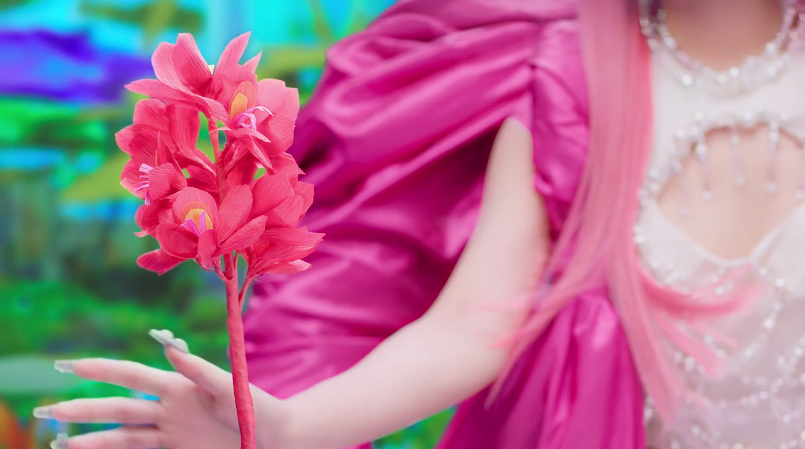 a close up of a person holding a flower