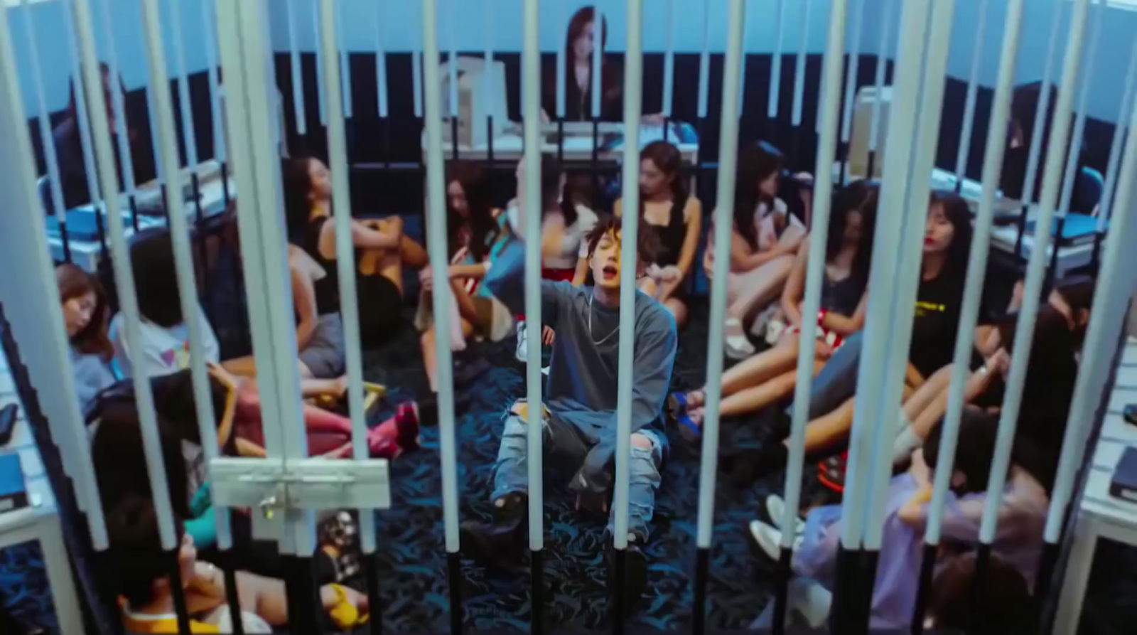 a man is sitting in a jail cell