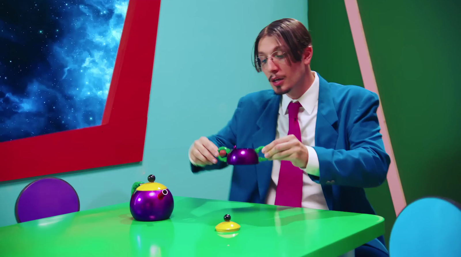 a man in a suit and tie playing with toys