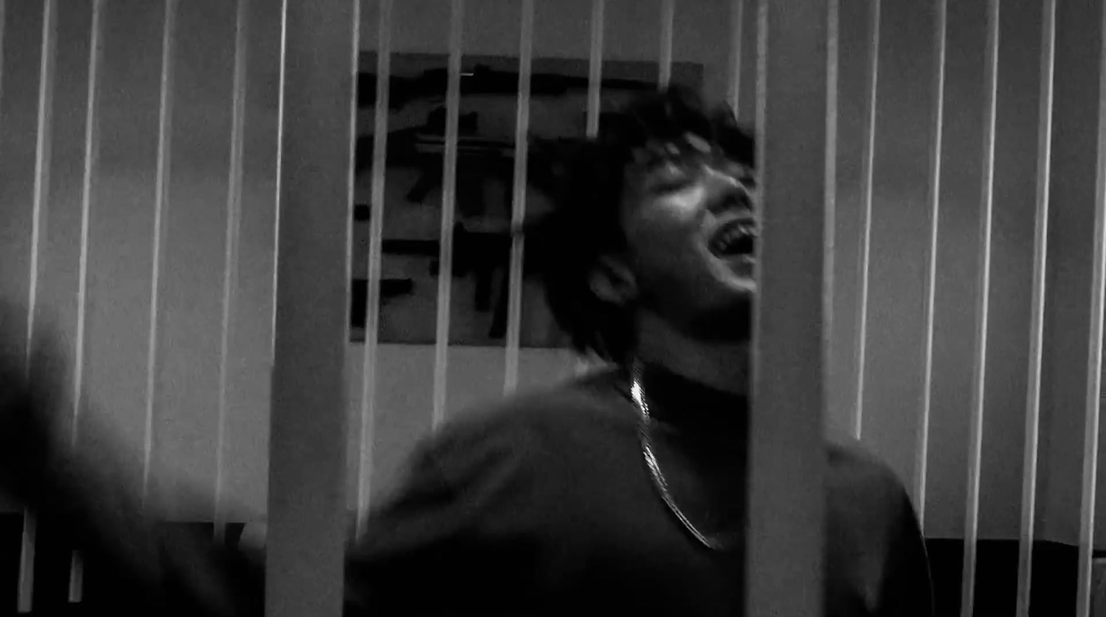 a man in a jail cell with his mouth open