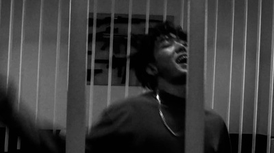 a man in a jail cell with his mouth open