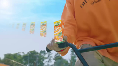 a person holding a carton of orange juice