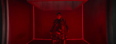 a person standing in a red room with a red light