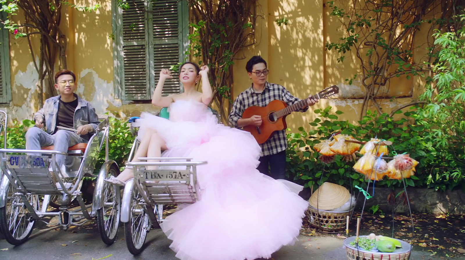 a woman in a pink dress sitting on a bike