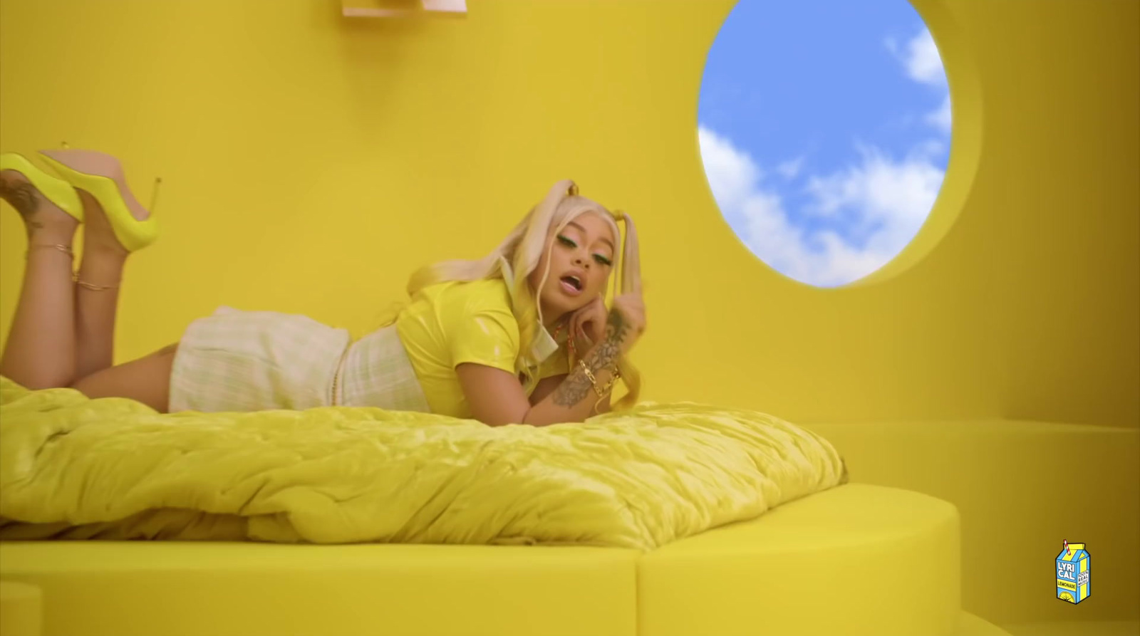 a woman laying on top of a yellow bed