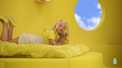 a woman laying on top of a yellow bed