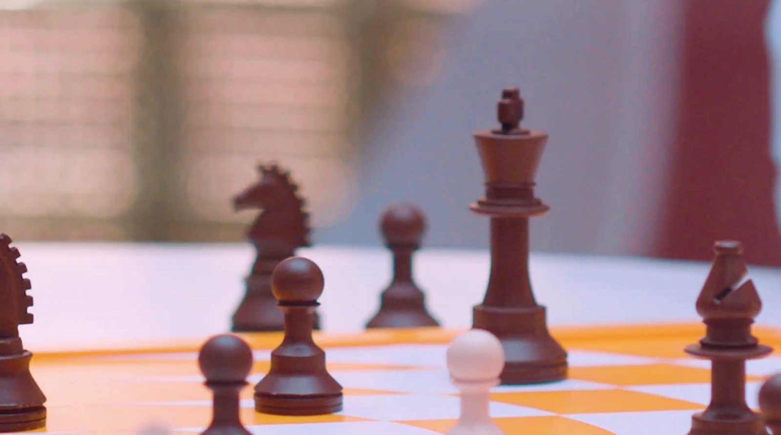 a close up of a chess board with pieces on it