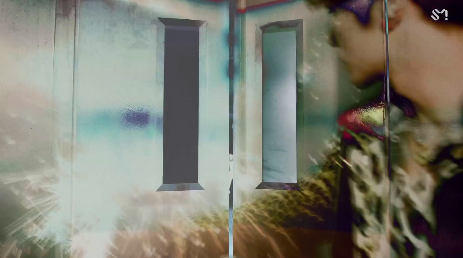 a woman standing in front of a wall with a clock on it