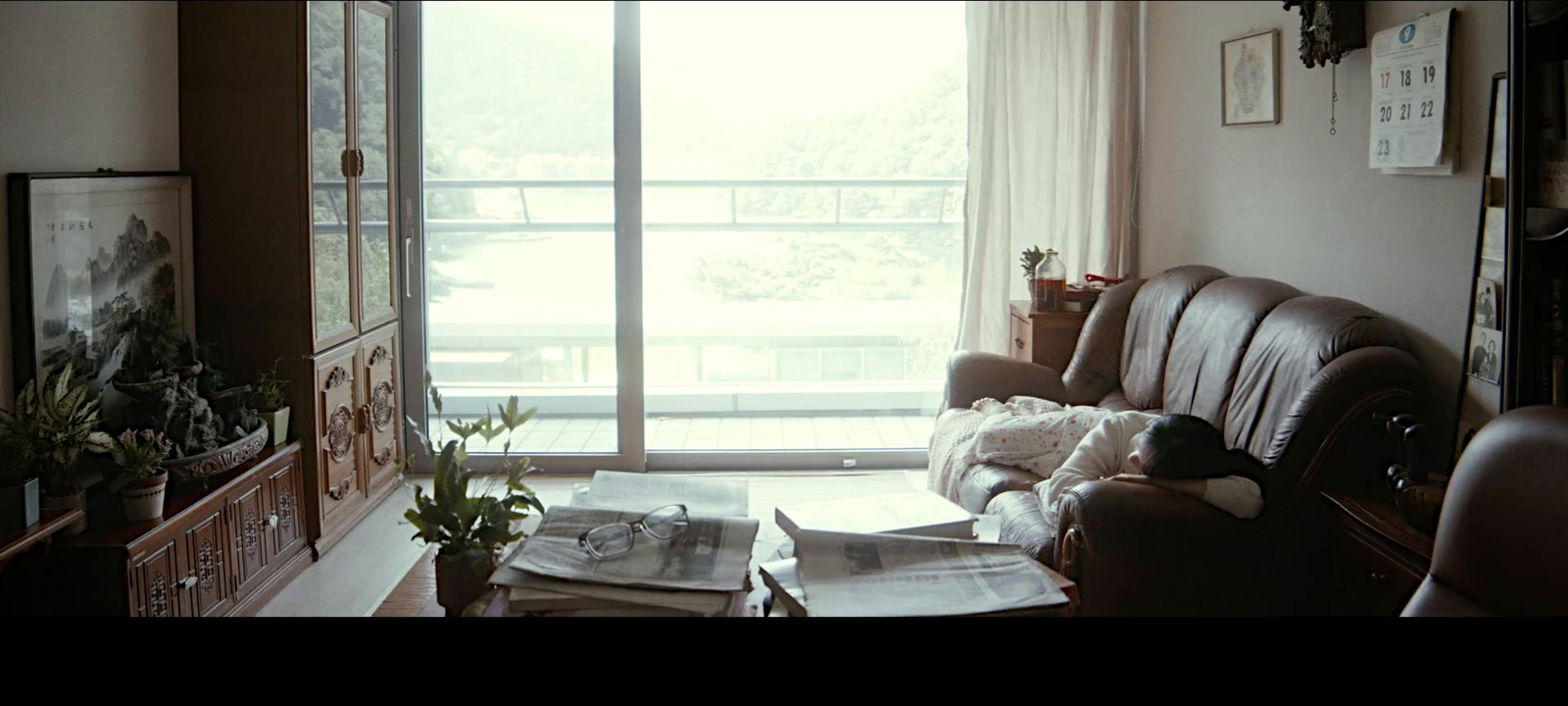 a living room filled with furniture and a large window