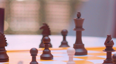 a close up of a chess board with pieces on it