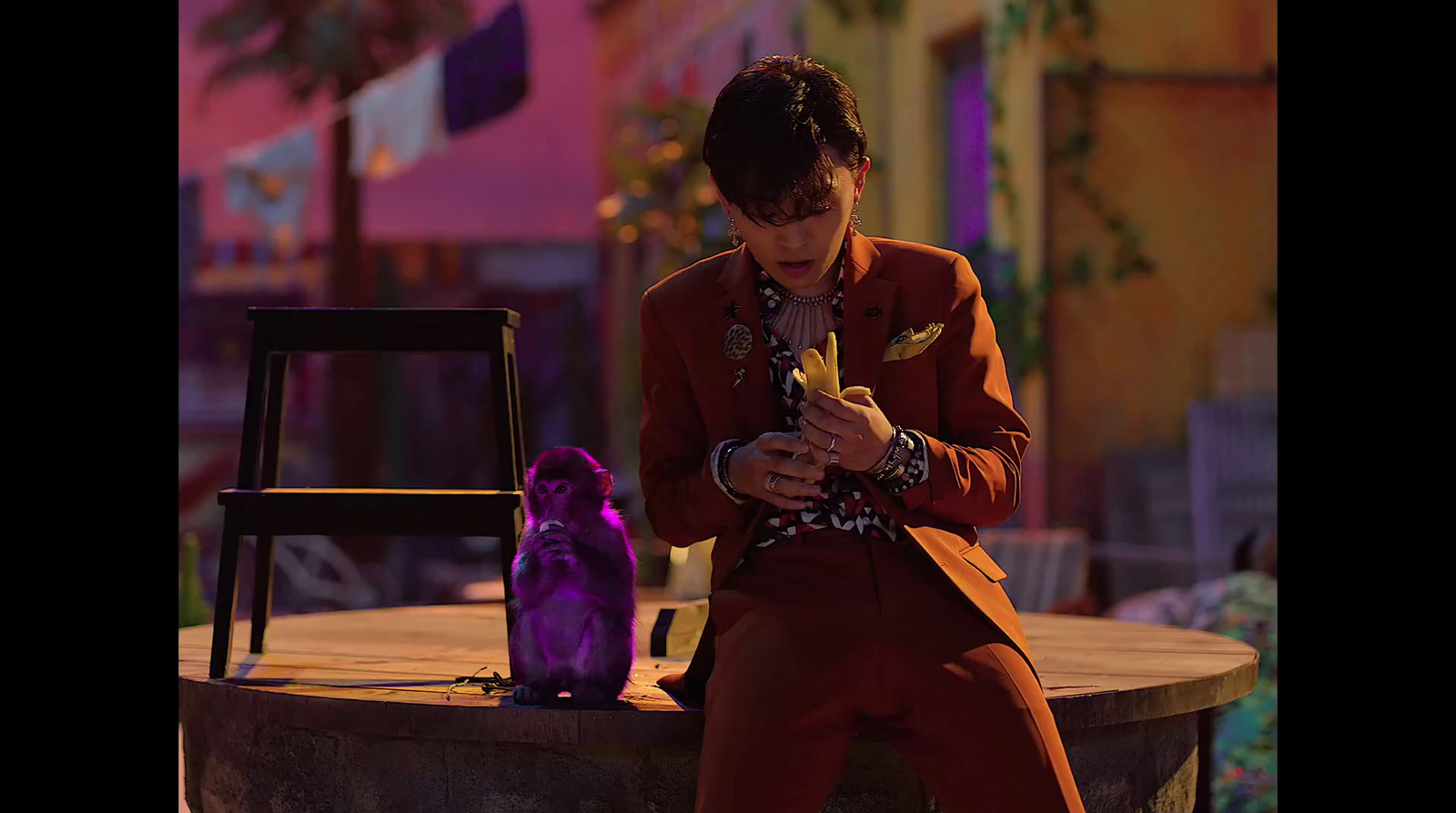 a man in a red suit looking at his cell phone