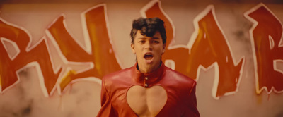 a man in a red outfit with his mouth open