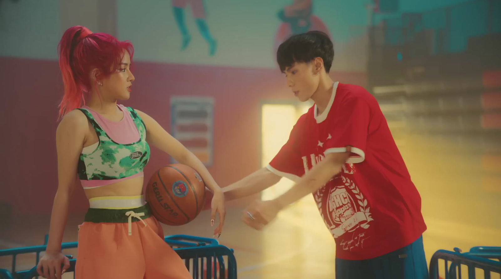 a boy and a girl holding a basketball