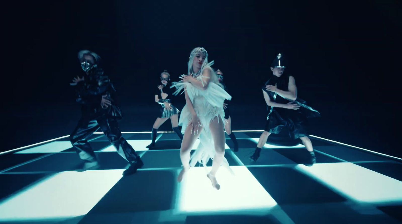 a group of dancers on a checkered floor