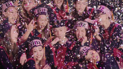 a group of people standing next to each other under confetti