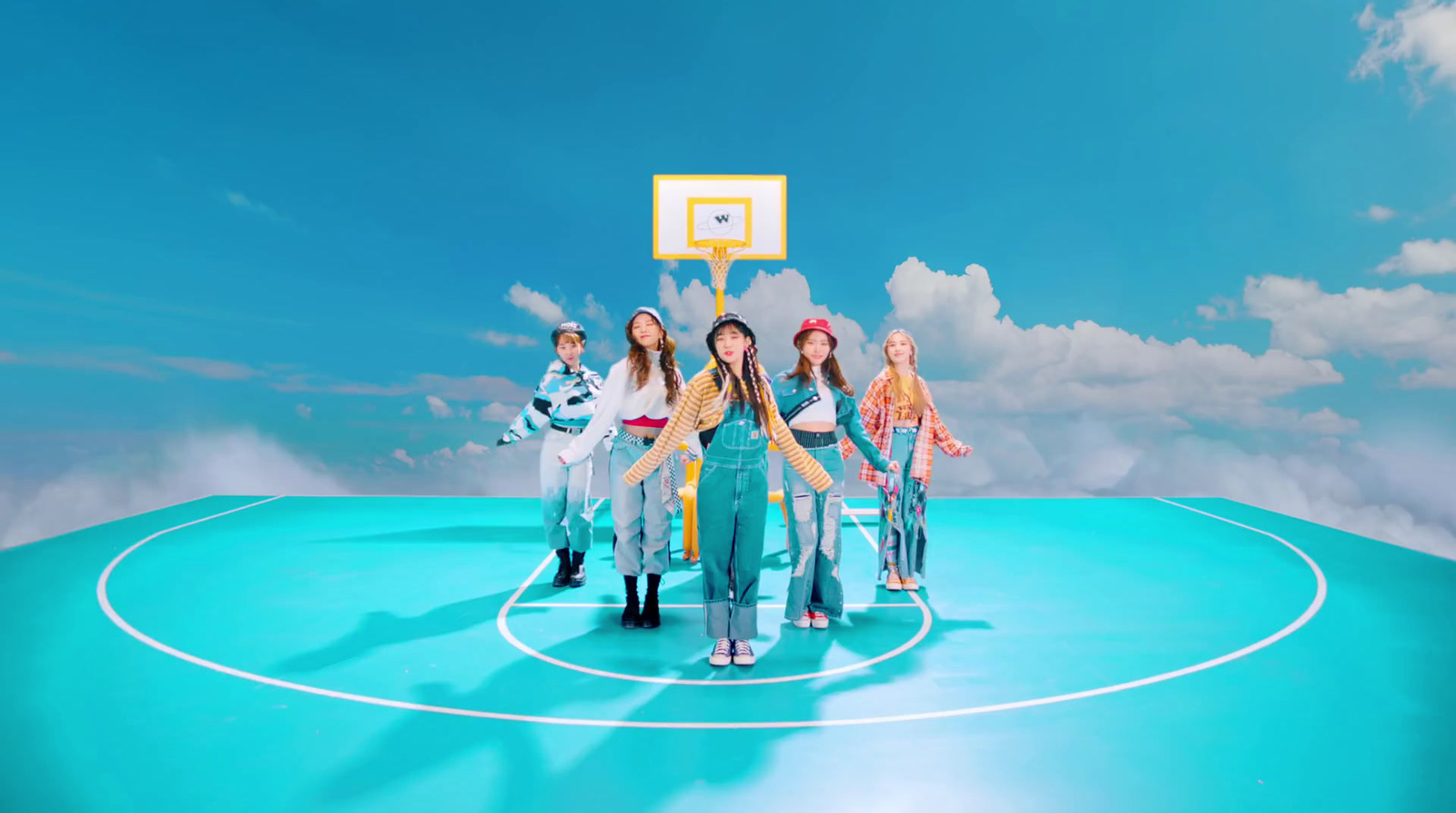 a group of young women standing on top of a basketball court