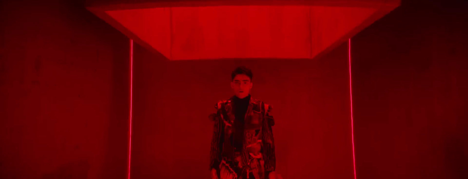 a man standing in a room with a red light