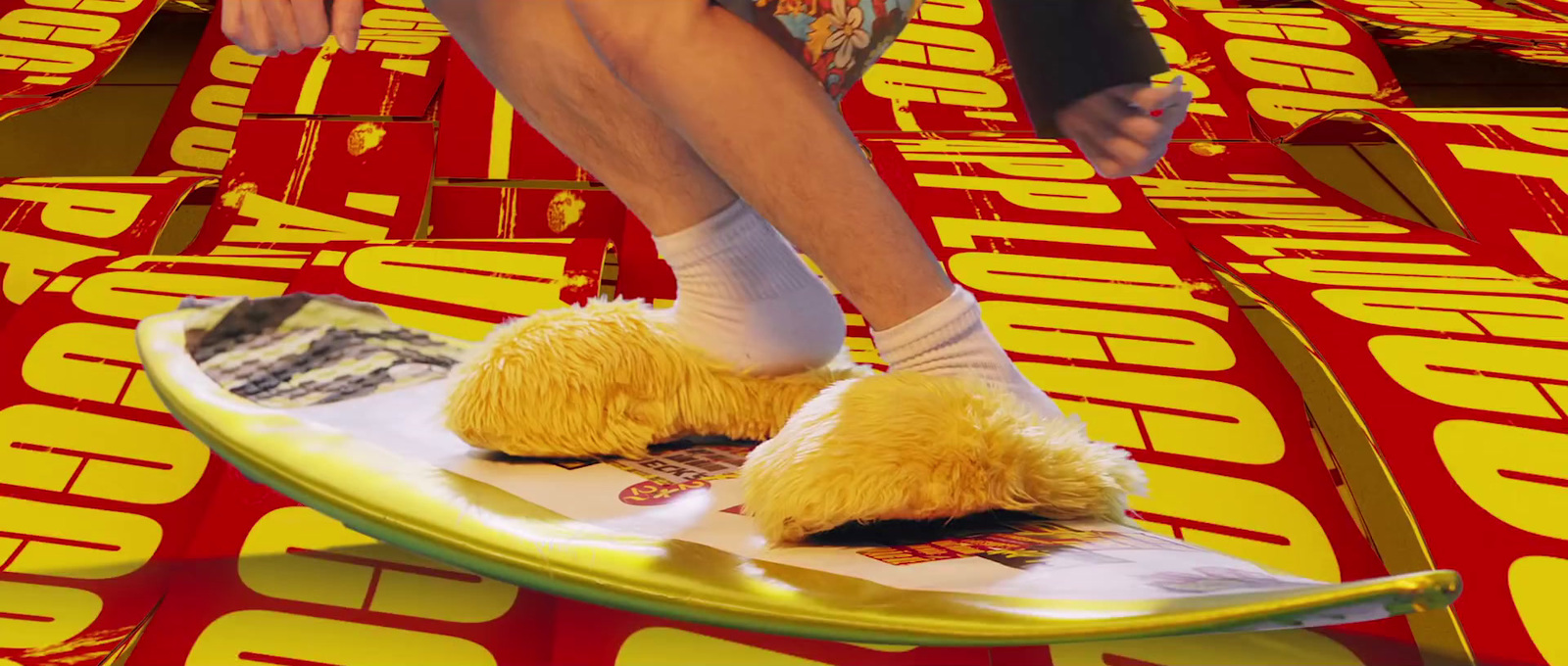 a person is sitting on a surfboard with furry feet