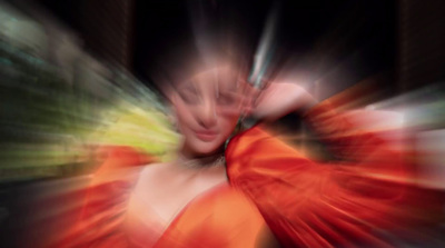 a blurry photo of a woman in an orange dress