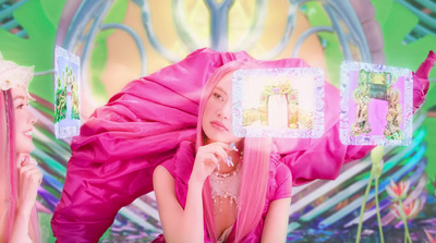 a woman in a pink dress is holding a mirror