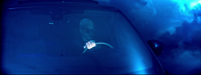 a man sitting in a car in the dark