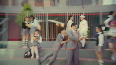 a group of people walking down a street next to each other