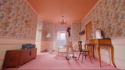 a room with a pink floor and wallpaper