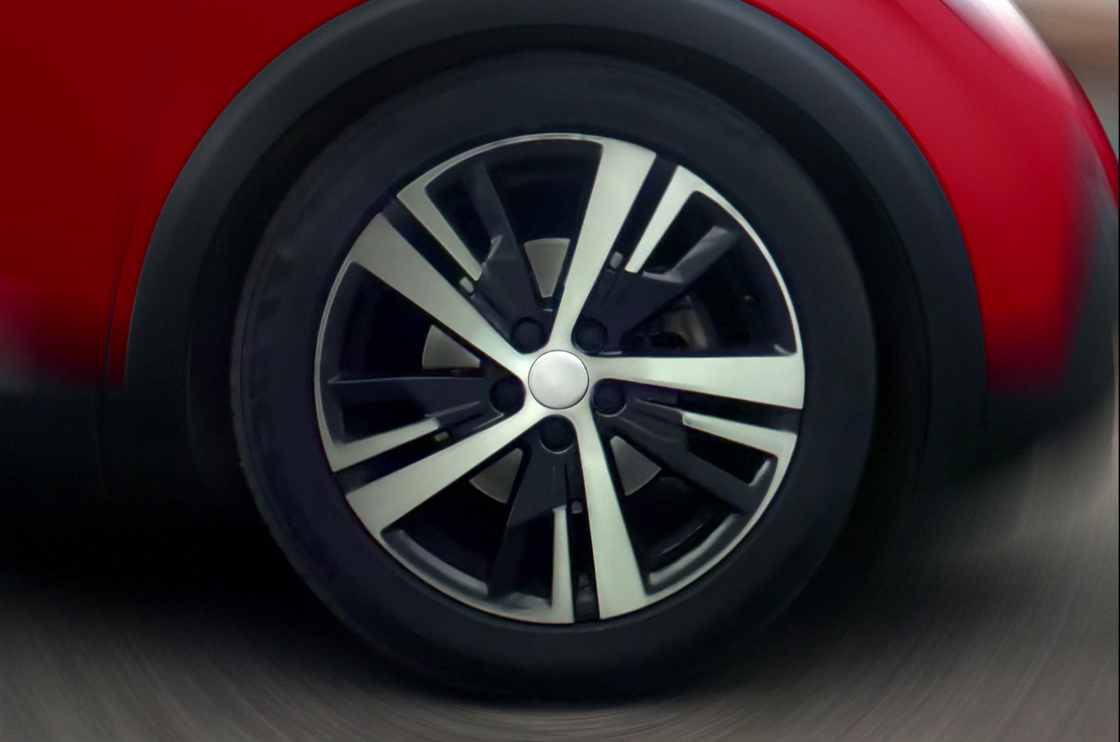 a close up of a car wheel on a road