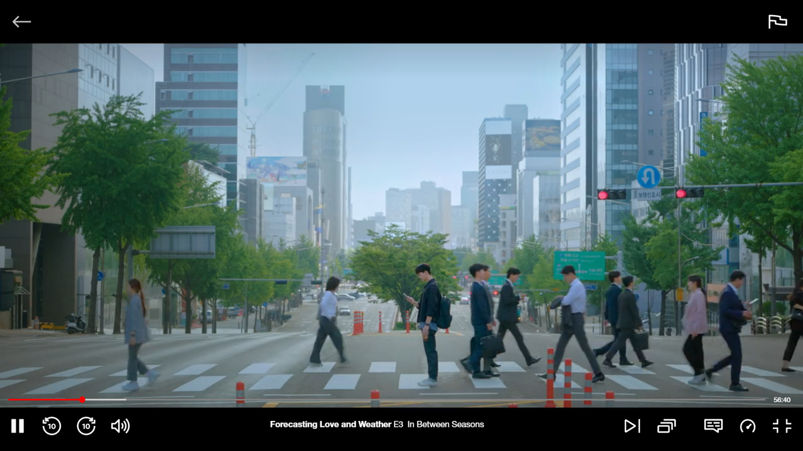 a group of people walking across a street