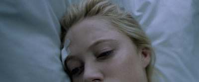 a woman laying in bed with her eyes closed