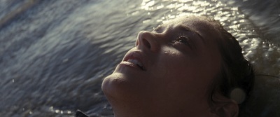 a close up of a person laying in the water