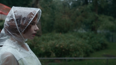 a woman wearing a plastic covering her head