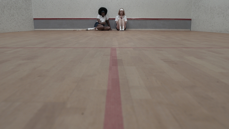 two girls sitting on the floor in a room