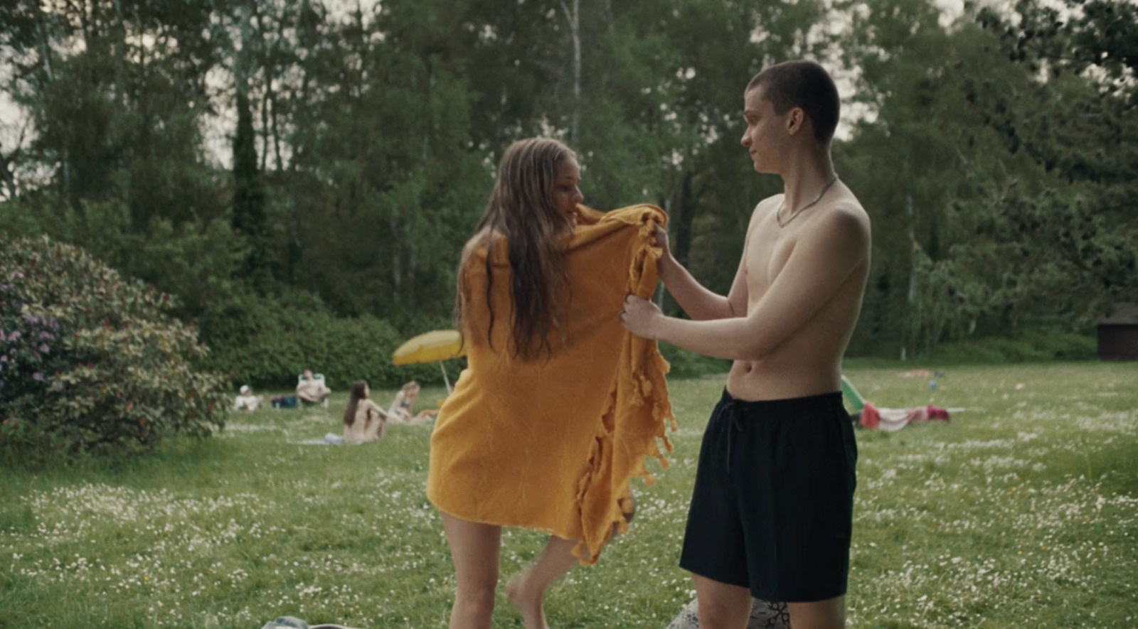 a man and a woman standing in a field