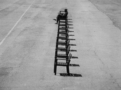 a row of chairs sitting on the side of a road