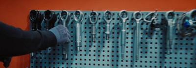 a person is putting scissors on a wall