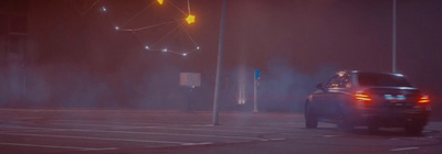 a car driving down a street at night