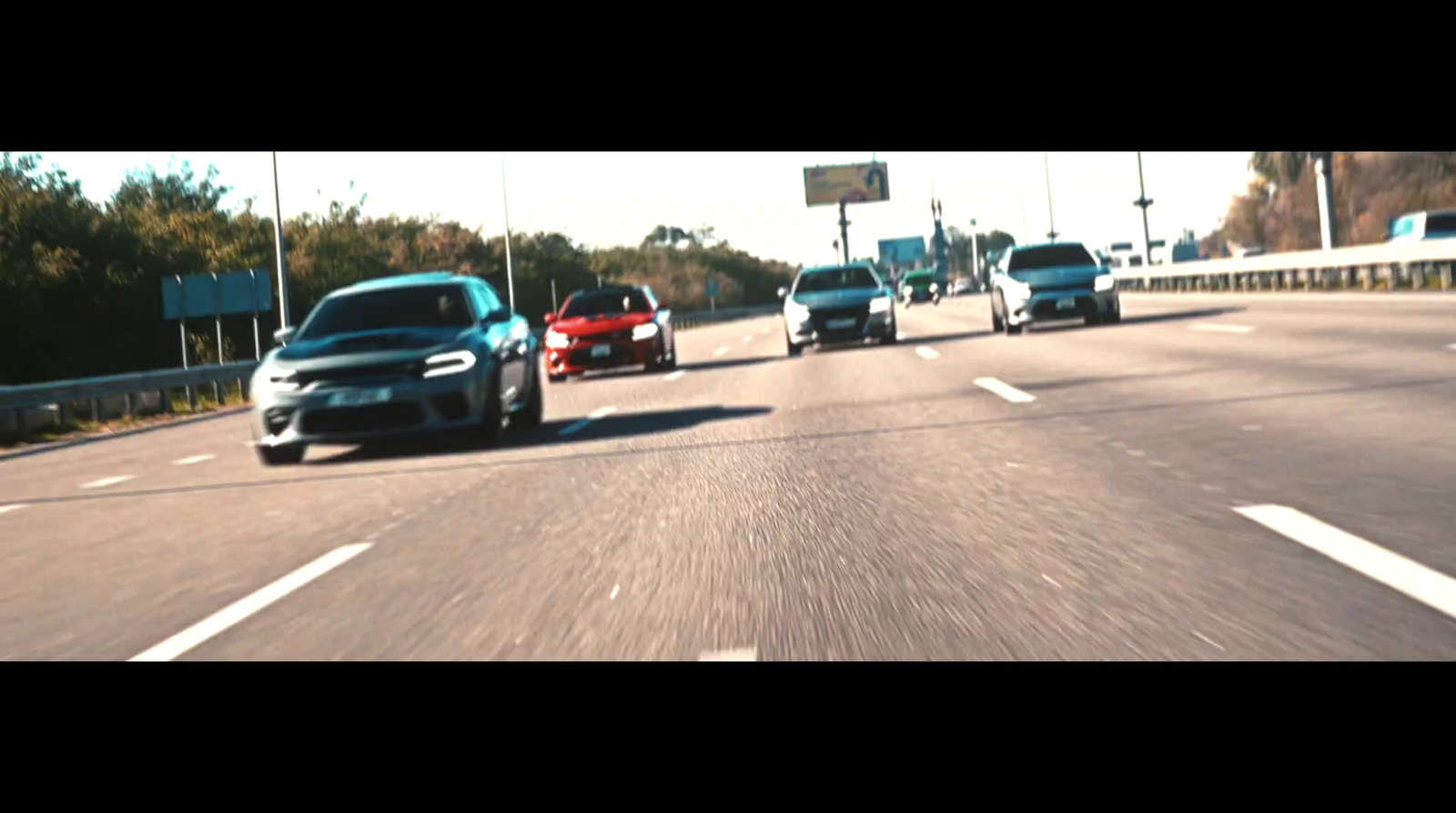 a couple of cars driving down a highway