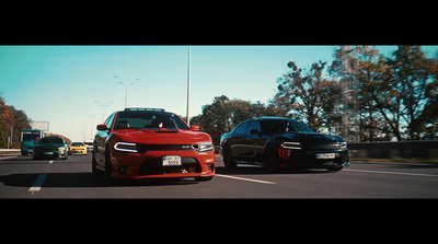 a couple of cars that are sitting in the street