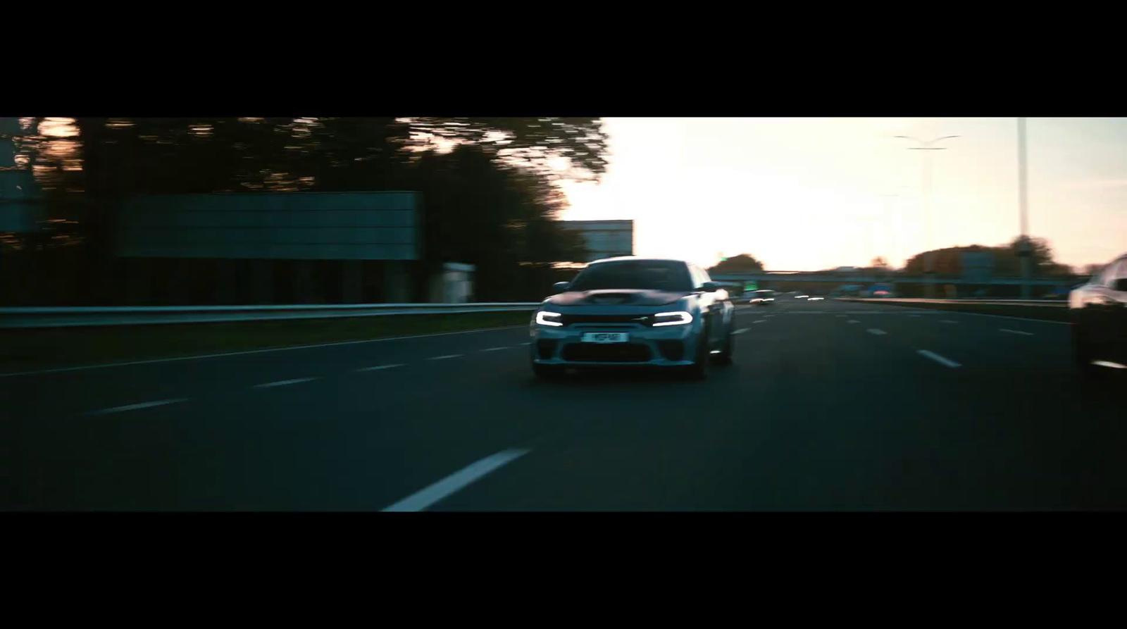 a car driving down a highway next to another car