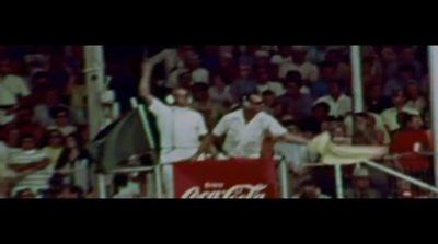 a man holding a tennis racquet on top of a tennis court