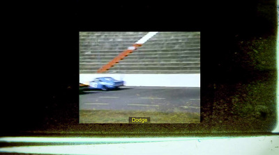 a blue car driving down a race track