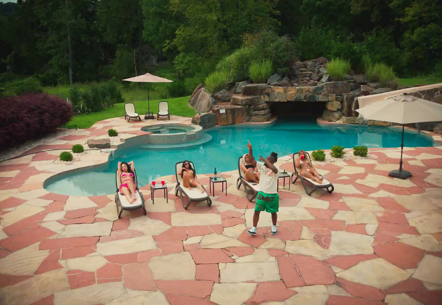 a group of people sitting around a pool